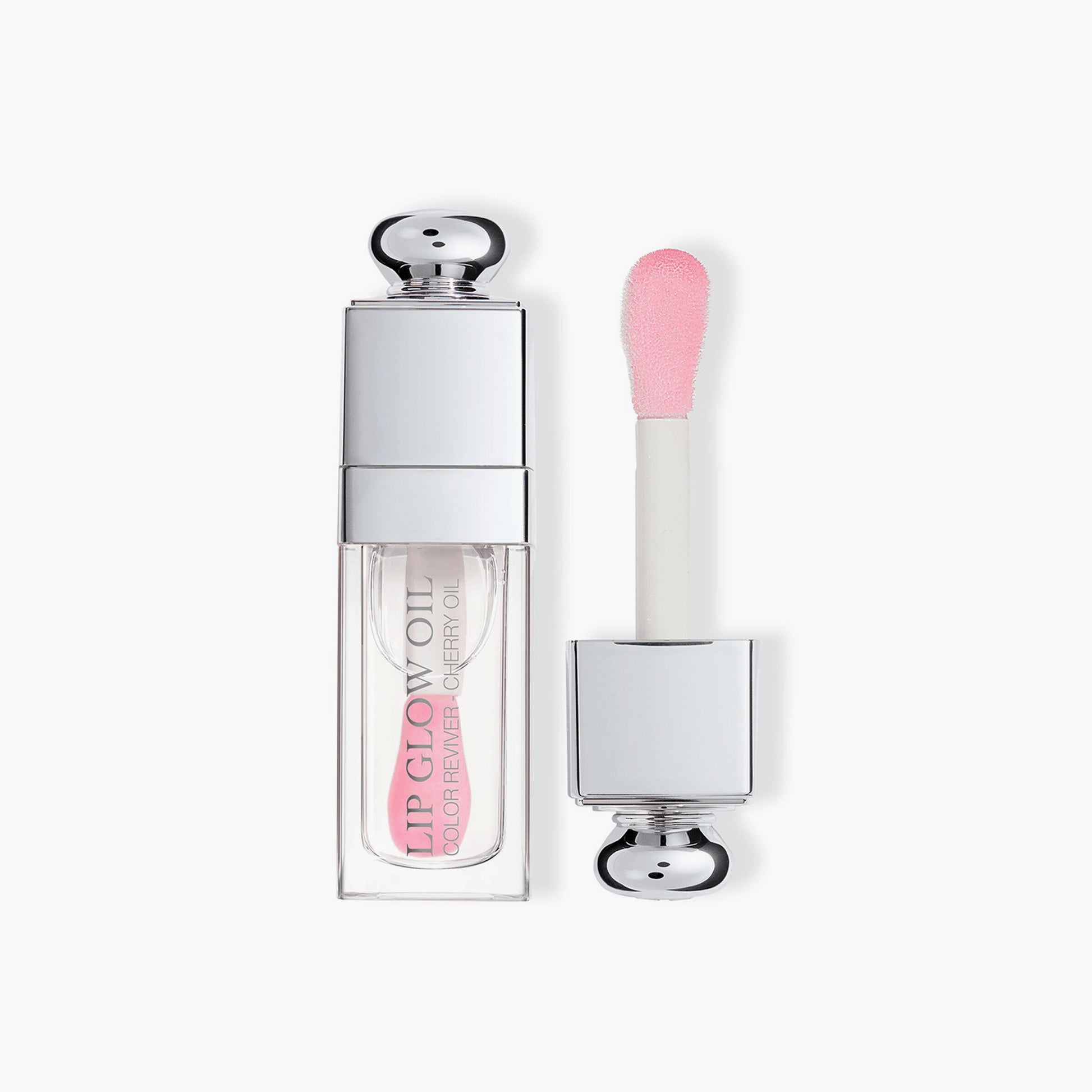 Dior Lip Glow Oil in delicate light pink shade with signature silver cap and specialized soft-tip applicator for precise application