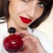 Dior Hypnotic Poison EDT Perfume bottle held in hand, showcasing the signature red design and luxury branding.