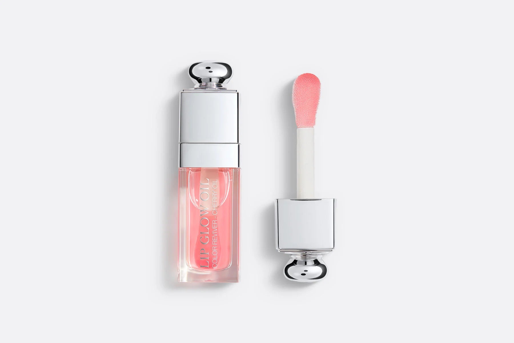 Dior Lip Glow Oil featuring pink tint and cherry oil for hydrating lip care with shine.