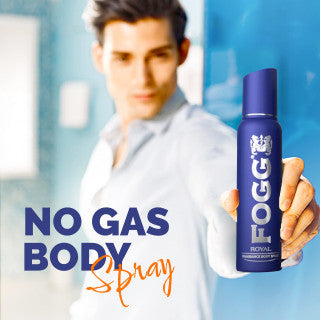 Man holding a Fogg body spray can with text 'No Gas Body Spray' on a blurred background