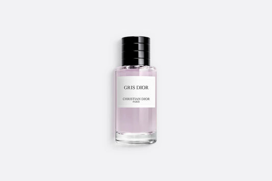 Sleek Gris Dior perfume bottle with pale pink fragrance, luxury Dior perfume featuring minimalist design and black cap on neutral background.