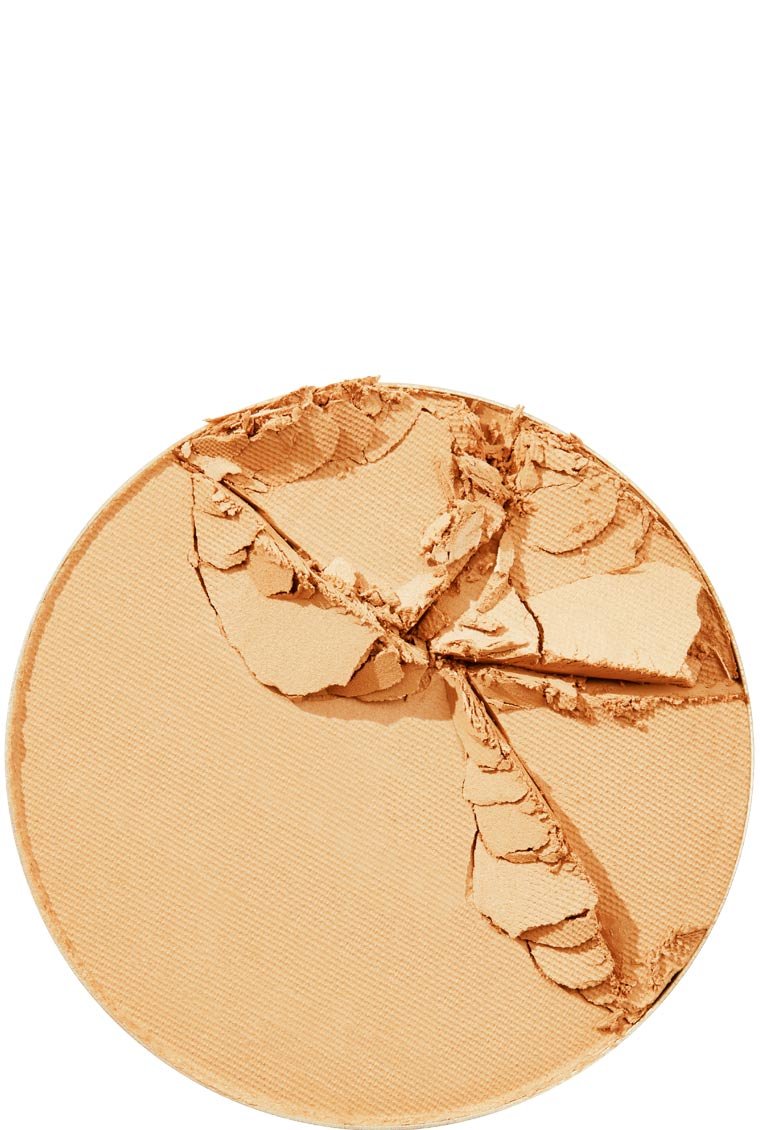* The texture of a cracked Maybelline Foundation Super Stay powder in a light beige shade, viewed from above.