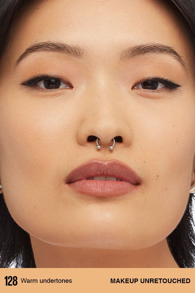 A model with warm undertones wearing an unretouched application of Maybelline Foundation in shade 128.