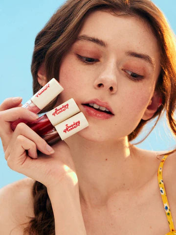 Sheglam-Sunday-Picnic-Layer-Cake-Lip-Oil-Set-woman-holding-three-lip-oils