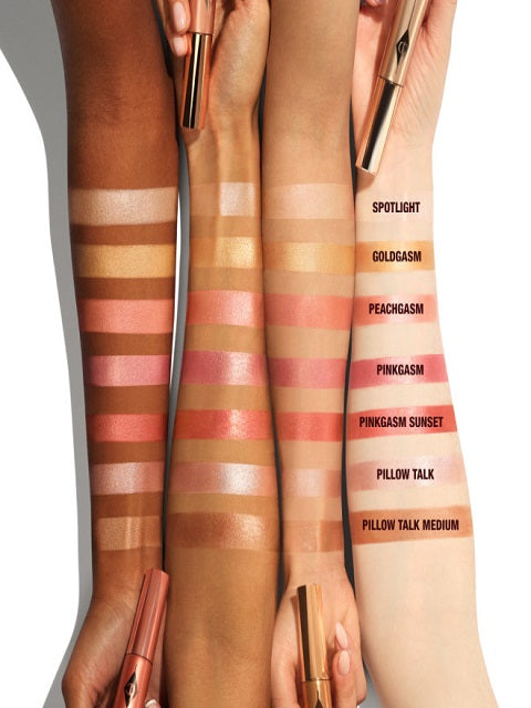 Multiple-arm-swatchs-of-Charlotte-Tilbury-Beauty-Light-Wand-Peachgasm-Highlighter-Blush