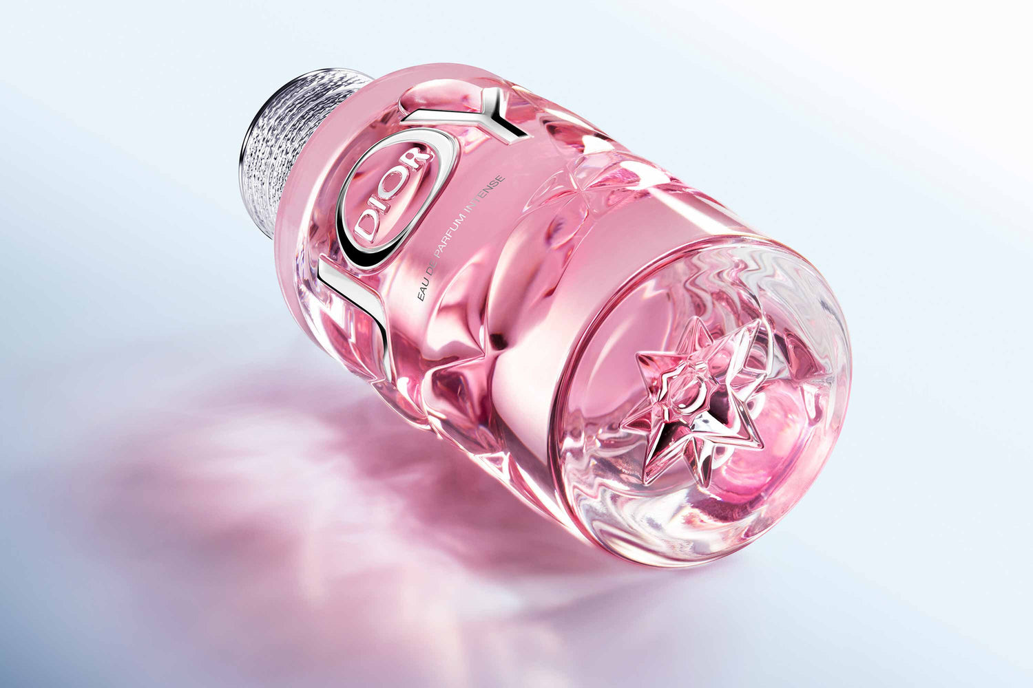 "Elegant pink crystal bottle of Dior perfume JOY EDP Intense 100ml with silver cap for sophisticated women"