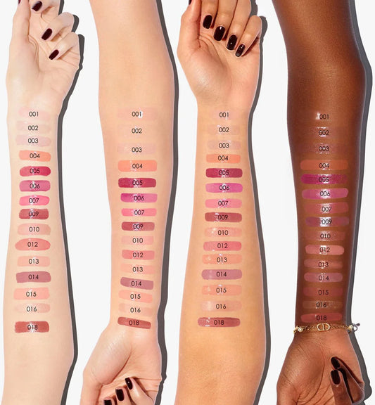 Arm swatches of the Dior Addict Lip Maximizer shade range on four different skin tones from light to deep.
