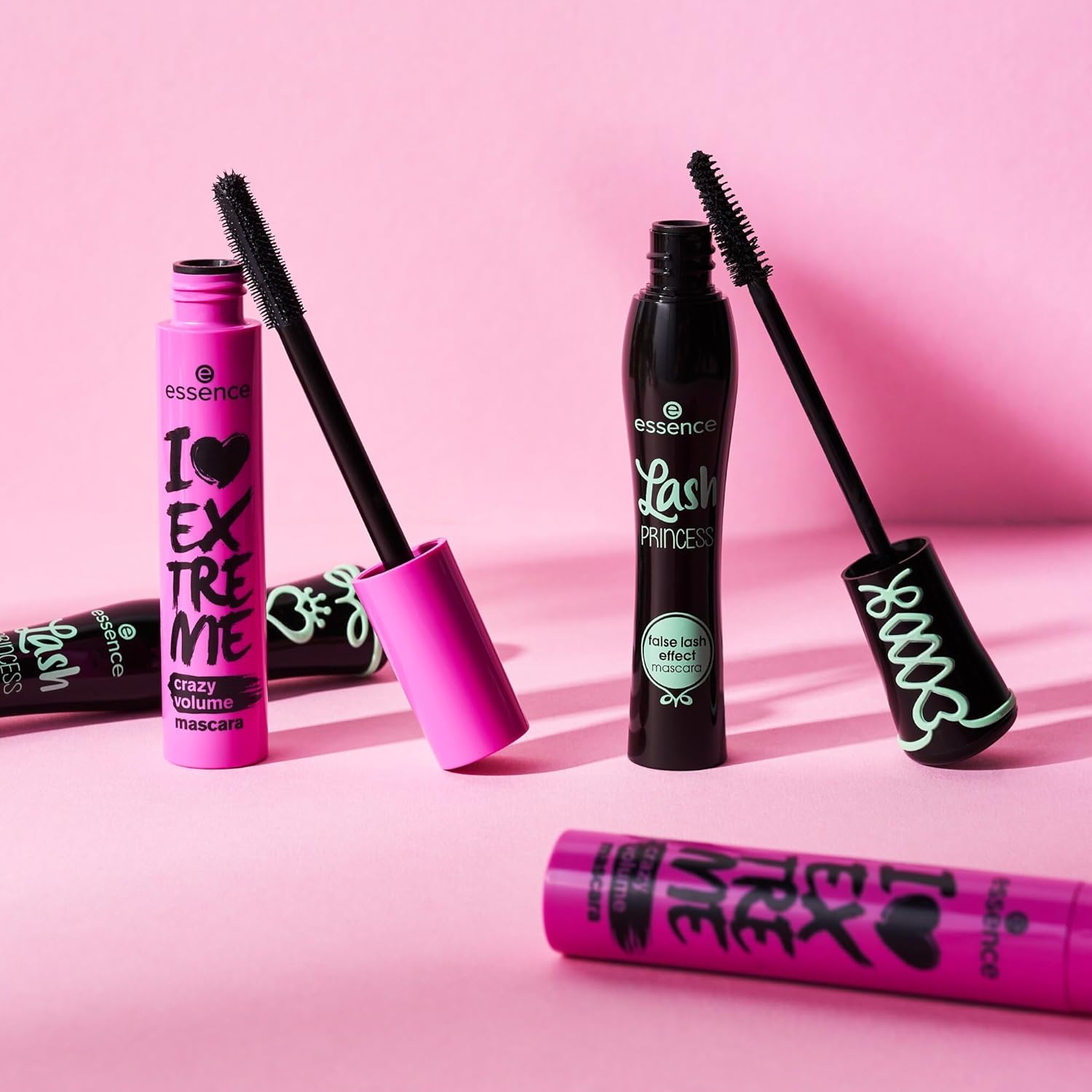 Essence mascara with different formulas on a pink background