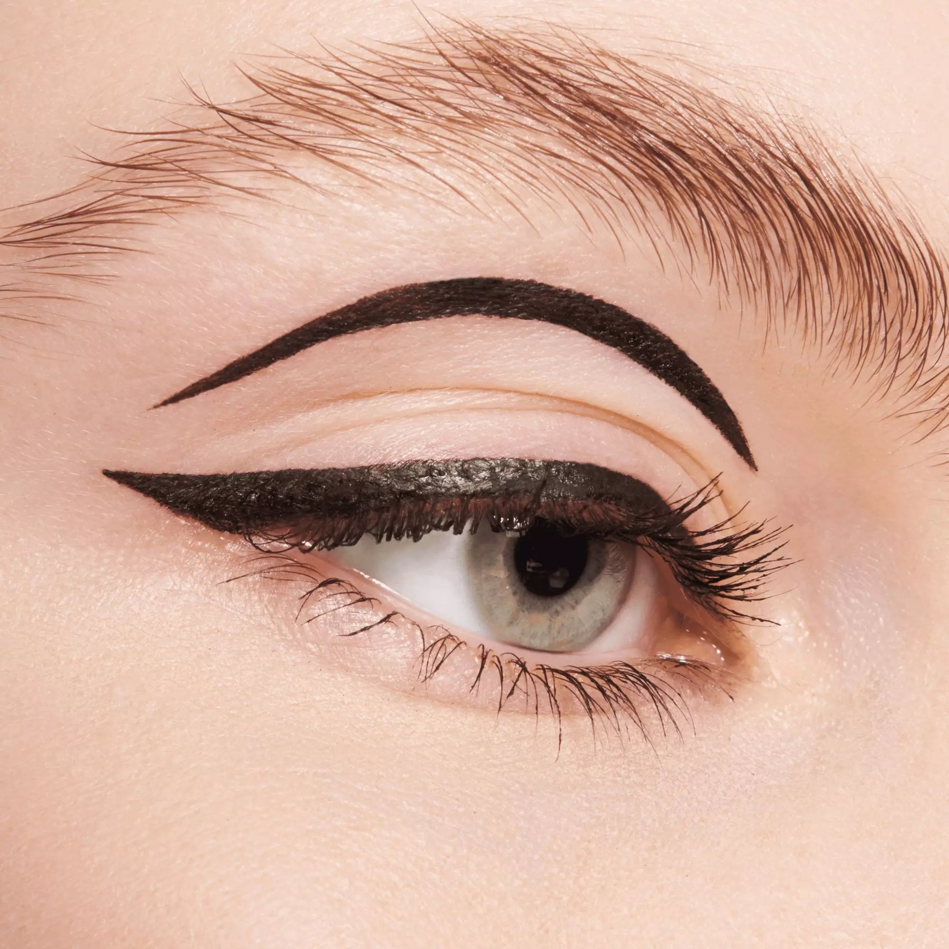 Close-up of a woman's eye with a defined eyeliner and eyebrow.